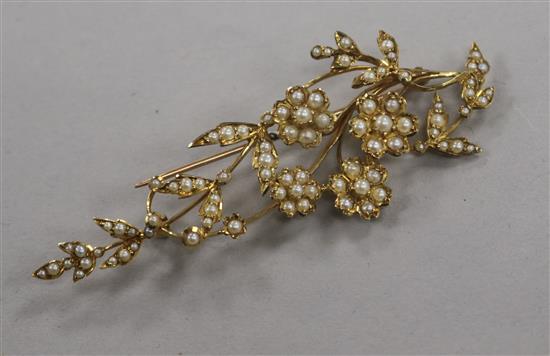 A yellow metal and seed pearl set spray brooch, 7cm.